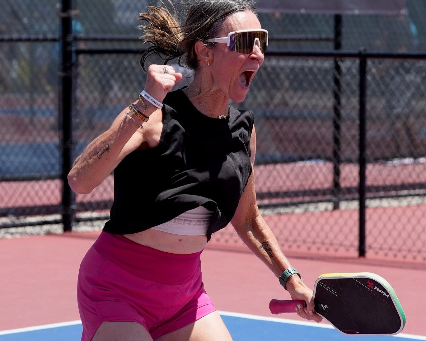 Karin Ptaszek-Kochis on a pickleball court holding her RPM paddle.